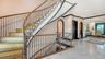 Grand curved staircase with custom ironwork