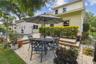 Another view of this great back yard space with a view on the right showing the paved pathway with an separate entrance to this wing.