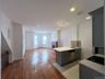 Kitchen with dishwasher, a peninsula, light countertops, a brick fireplace, and recessed lighting