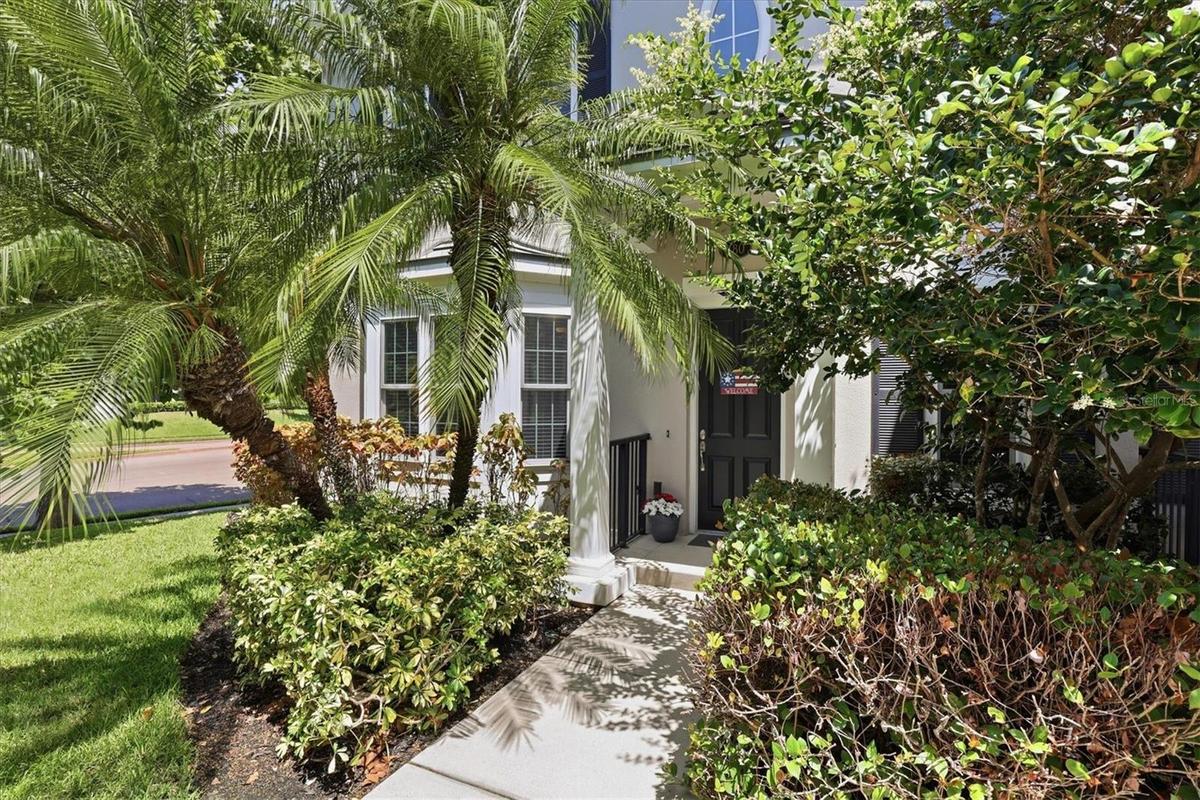 Elegant columns define the covered entrance of this luxury townhome.