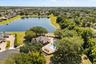 Ariel view of community pool, clubhouse, playground and pond