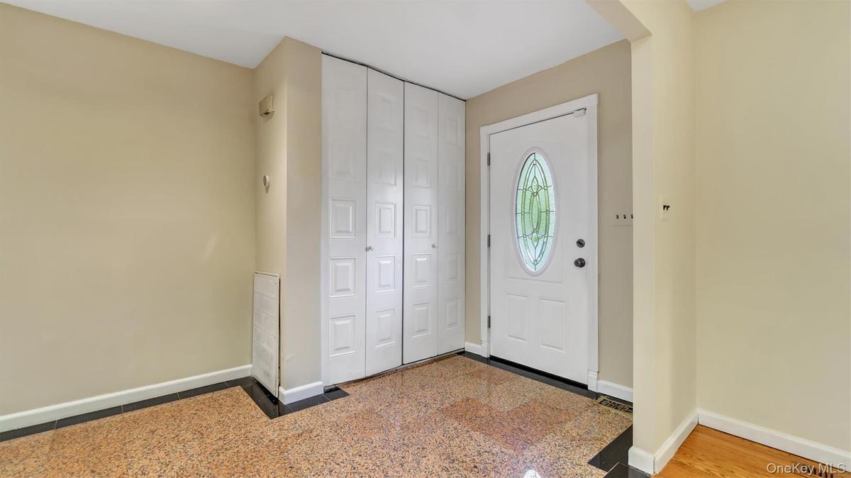 Entryway with visible vents and baseboards