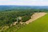 Very high drone shot of the potential house site and pond