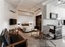 Bedroom featuring track lighting, concrete floors, and a wall mounted AC