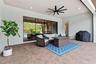 Covered patio offers protection from the Florida sun when needed and includes a hurricane rolldown shutter.
