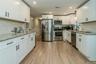 Kitchen featuring white cabinets, stainless steel appliances, light hardwood / wood-style floors, and sink