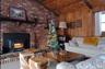 Carpeted living area featuring wooden ceiling and wood walls