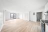 Unfurnished living room with light wood finished floors, electric panel, and a wall mounted air conditioner