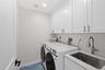 2nd floor laundry room equipped with additional sink and plenty of storage!