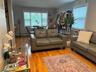 Living room with a baseboard radiator and wood finished floors