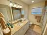 Bathroom with tile patterned floors, vanity, toilet, and curtained shower