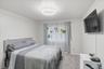 Carpeted bedroom with baseboards