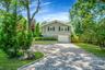 View of front facade with decorative driveway and an attached garage