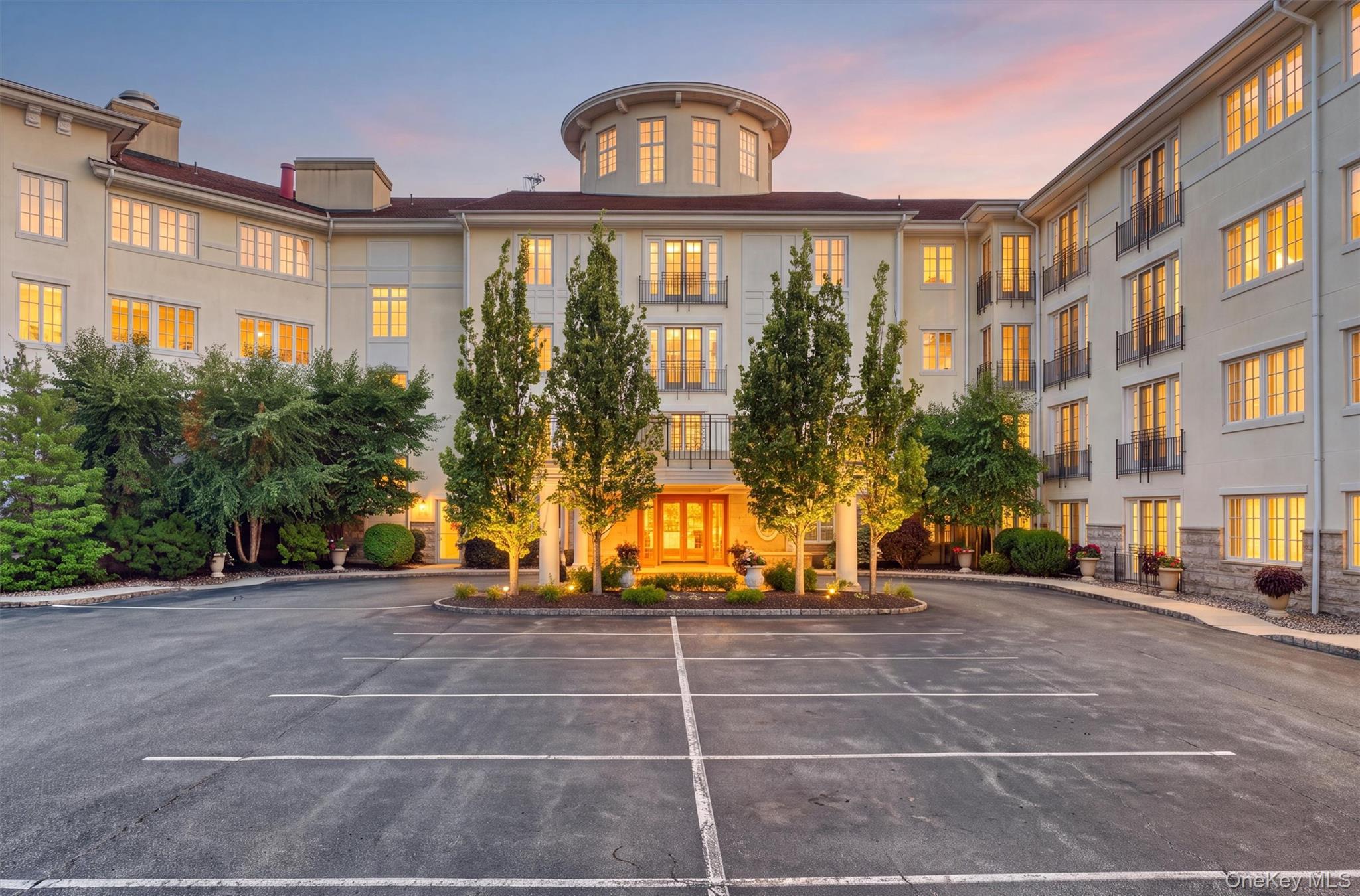 Distinguished entrance surrounded by beautifully landscaped grounds.(virtually staged dusk)