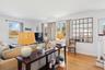 Living room featuring light wood-style flooring, crown molding, and plenty of natural light