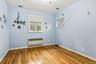 Empty room featuring radiator heating unit and light wood-style flooring