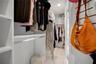 Both closets in the primary were thoughtfully finished in California Closet Design