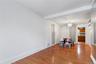 Unfurnished dining area with wood finished floors, a chandelier, and beam ceiling
