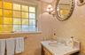 Bathroom featuring vanity and wallpapered walls