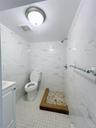 Full bath featuring tile walls, a shower stall, and vanity