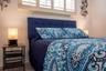 Master with queen bed, side tables with lamps.