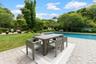 Swimming pool featuring a patio area, a yard, and outdoor dining area
