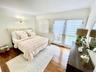 Bedroom with access to outside, ornamental molding, and wood finished floors