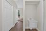 Laundry Room with Stairs to Unfinished Attic