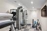Workout room featuring light flooring, recessed lighting, and ornamental molding