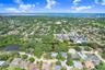 Drone view of property and neighborhood