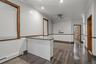 Spare room with a baseboard heating unit, ornamental molding, dark wood-style flooring, and ceiling fan
