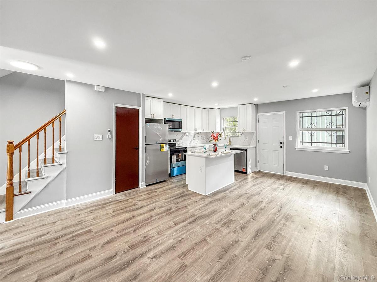 Unit 2 -Kitchen /Dining with exit to the deck and backyard