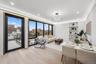 Living room featuring light wood finished floors, a view of city, and recessed lighting
