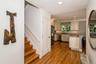 Kitchen with recessed lighting, dark wood-type flooring, light stone countertops, a peninsula, and appliances with stainless steel finishes