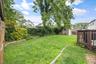 Backyard – Beautifully sized backyard showcasing a spacious deck, lush lawn, and mature landscaping. An inviting outdoor retreat with ample space for 