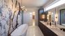 Primary bath with dual vanities, gorgeous cabinetry, free standing tub and breathtaking feature wall. Large shower