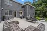Back of property with a patio, outdoor dining space, and brick siding