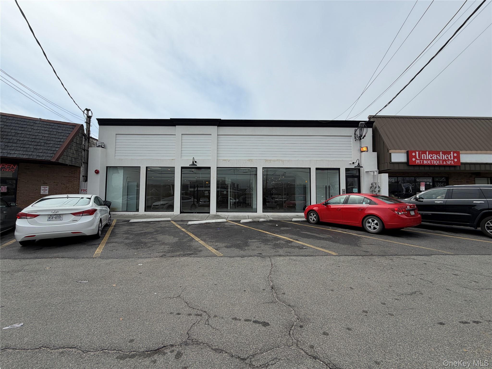 View of building exterior featuring uncovered parking