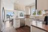 Kitchen featuring butcher block countertops, sink, hanging light fixtures, kitchen peninsula, and stainless steel appliances