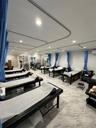 PT Room with tables set up for clients with recessed lighting and a wall mounted mini split