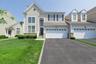 Light-toned siding exterior with stone accenting