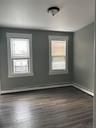 Unfurnished room featuring dark wood finished floors