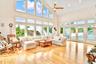 Living room featuring high vaulted ceiling, light wood-style floors, a ceiling fan, and recessed lighting