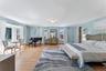 Bedroom with light wood-style flooring and crown molding