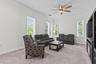Deep crown molding adds elegance and windows flood the space with natural light.