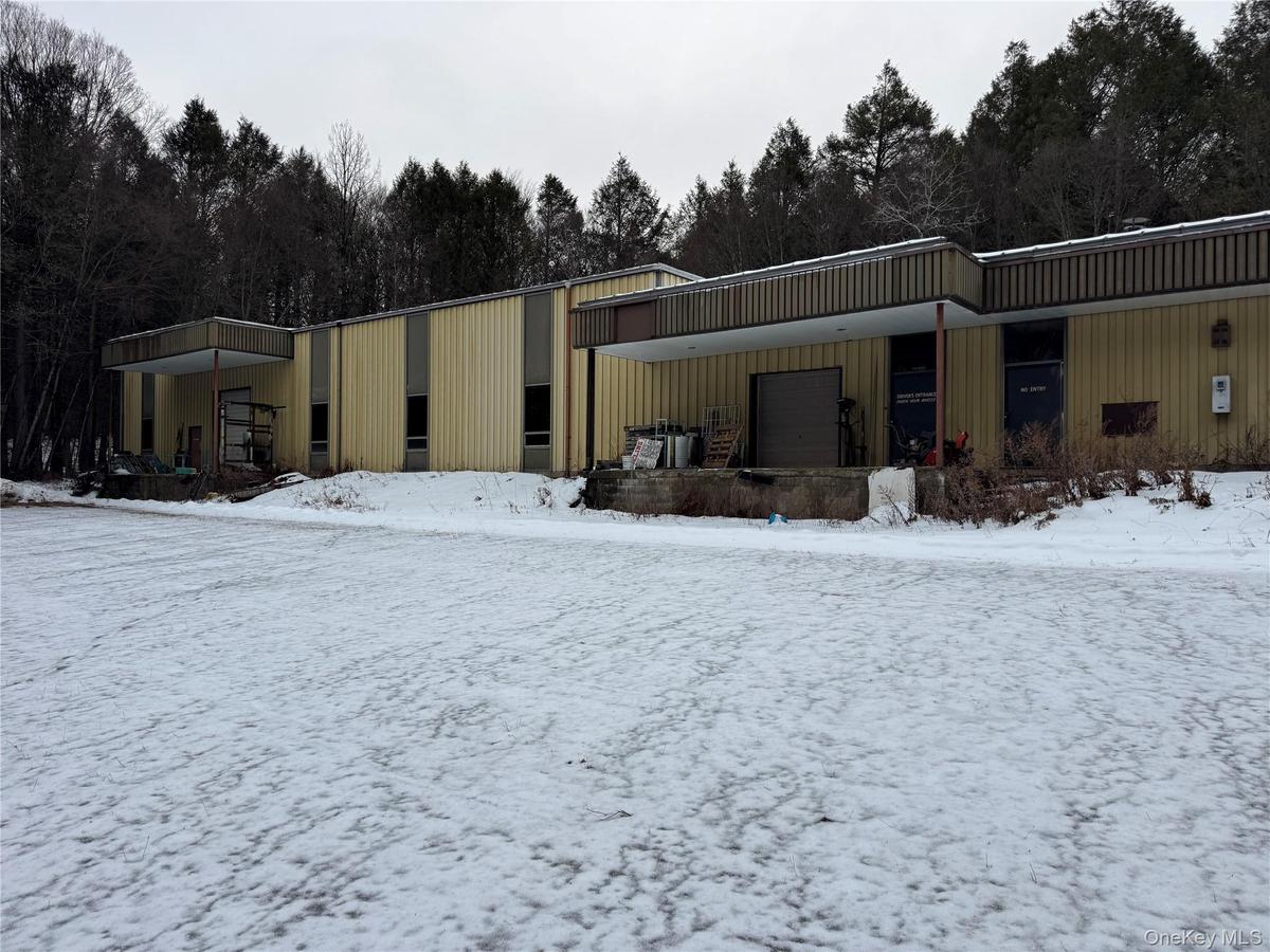 Snow covered building with an attached garage