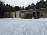 Snow covered building with an attached garage
