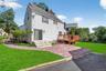 Back of property with a patio, a wooden deck, and a chimney