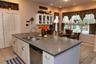 Open concept kitchen with breakfast nook overlooking pool area
