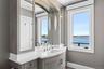 Bathroom with a water view, vanity, and baseboards